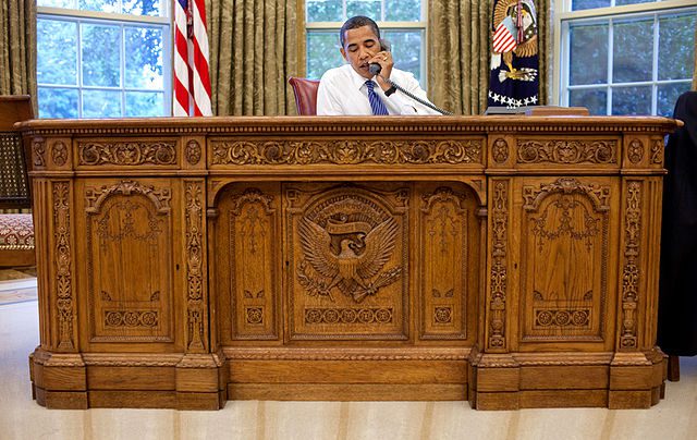 moving company for donation centers: President Obama in the oval office on the phone